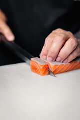 Asian Chef Cutting Salmon Fillet