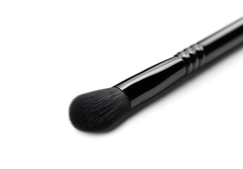 Black makeup brush isolated on a white background, close-up.