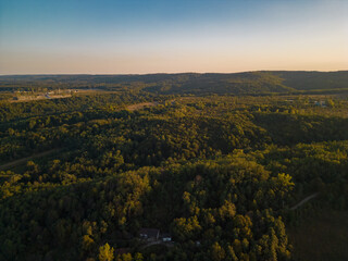 Fototapeta premium Rural landscape viewed from the drone. A village in Romania located on the edge of a lake near the wild forest