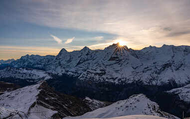 amazing sunrise view behind the mountains on 3000m on Schilthorn in the Swiss alps