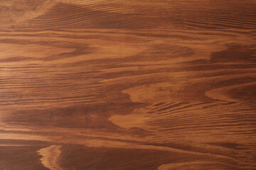 Fototapeta premium Applying walnut wood stain. Texture of wooden surface as background, top view