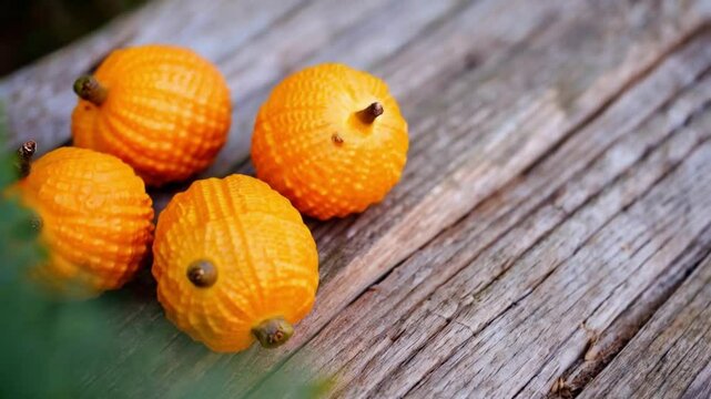 Fresh gac fruits on an old wooden background, 4k video animation