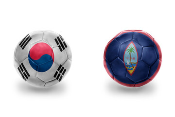 Obraz premium football balls with national flags of guam and south korea ,soccer teams. on the white background.