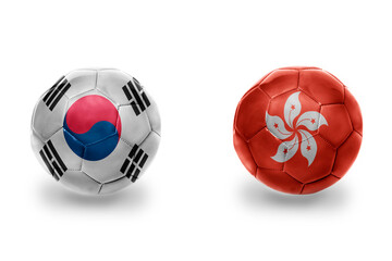 Obraz premium football balls with national flags of hong kong and south korea ,soccer teams. on the white background.