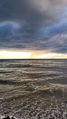 Obraz premium Sea, beach and pebbles, clouds in the sea. 