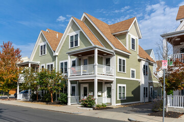 Elegant two-story family homes with  gable roofs and balconies in a peaceful neighborhood  in...