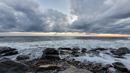 Obraz premium Sea, beach and pebbles, clouds in the sea. 