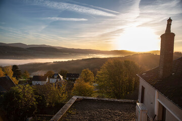Autumn landscape in Burgundy at Château-Chinon in France, with forests, hills and houses at sunrise