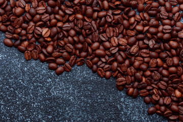 Roasted coffee beans in bowl. Rusty background for coffee shop menu. Top view and copy space.