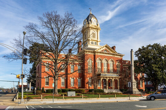 MONROE, NC, USA-28 JAN 2023: Historic 1886 late Victorian Courthouse, with mirror image front and rear, clock tower, sunny blue sky.