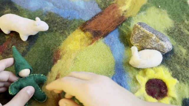 Close-up of Hands payinga Felted Wool Bunny Figurine, Crafting Handmade Animal Toys, Creative Art Process in Warm, Waldorf toys