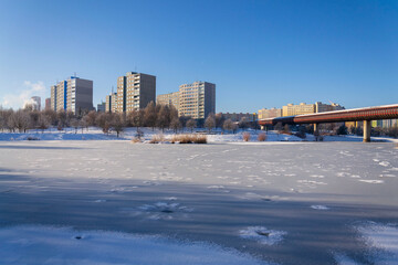 Insulated panel house apartments behind trees, high-rise block of flats, prefabricated tower blocks from concrete slabs, large panel system building