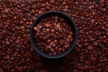 Fototapeta premium Roasted coffee beans in bowl. Rusty background for coffee shop menu. Top view and copy space.