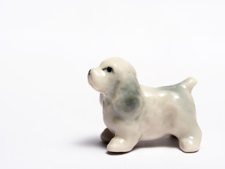 In tis photoillustration Vintage porcelain figurine of dog on white background