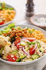 Vegan lunch bowl with lentils, roasted vegetables and chickpeas, pearl couscous salad