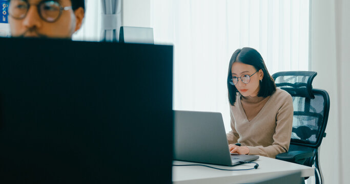 Group Adult Asia male, female freelance typing write prompt AI bot IT app smart program nomad, video game, terminal with coding language, user interface, designer, big data center on desktop computer.