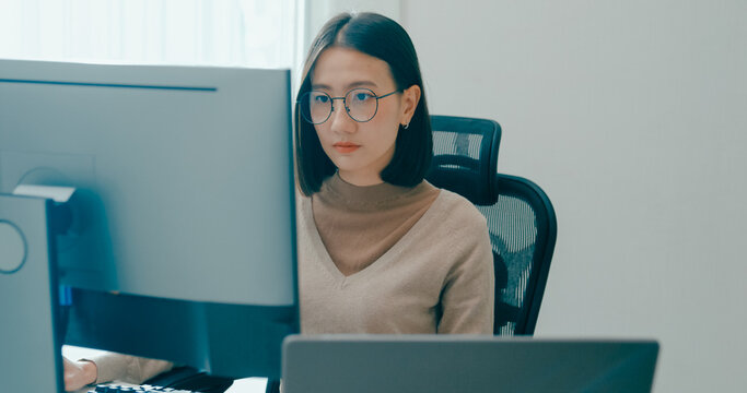 Young adult Asia female freelance eyeglasses typing write prompt AI bot IT app smart program nomad, video game, terminal with coding, user interface, designer, big data center on desktop computer.