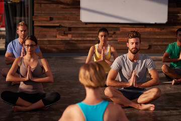 Prayer hands, meditation or instructor with people in yoga class for chakra energy, therapy and...