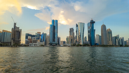 Fototapeta premium Dhow Cruise during sunset time at Dhow harbour background skyscrapers.