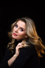 Fototapeta premium Portrait of a pretty young woman on a black background