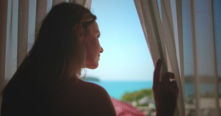 Close up woman look in window enjoy ocean view. Female relax in Phuket, Thailand exotic nature....