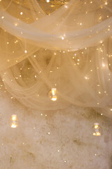 Hanging candles and garland under canopy © aprilante