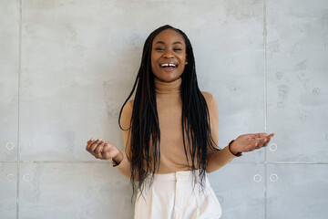 A professional black businesswoman with a radiant smile stands in a sleek office, exuding...