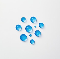 Fototapeta premium Transparent blue water droplets on a white background