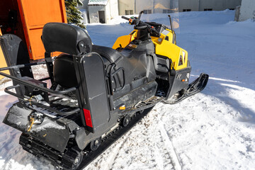 Snowmobile in winter mountains with ski sport