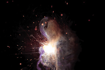 A bright flash of light and a sheaf of sparks in a cloud of smoke. Miniature Universe. Design...