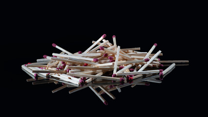 Pile of match sticks on glass isolated on black background