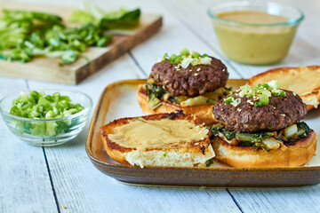 Asian style beef sliders with sauteed bok choy and spicy aoli