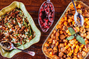 Holiday side dishes consisting of sweet potato stuffing, cranberry sauce and green bean casserole