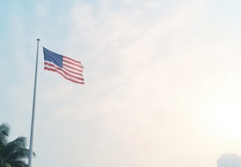 American flag waving in the breeze against a cloudy sky