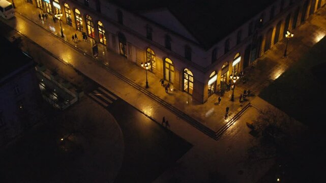 Aerial static shot of the Arsenal at Metz. People walking by. Late night concert. Winter night in Metz. Place de la r&eacute;publique of Metz. Illumination.