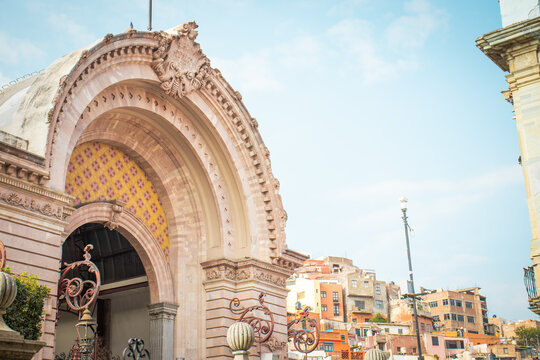 C&aacute;lida fotograf&iacute;a de la entrada al mercado Hidalgo ubicado en Guanajuato, M&eacute;xico, con varias casas de colores al fondo.