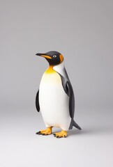 Fototapeta premium Majestic emperor penguin standing on a plain background