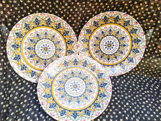 Decorated  antique ceramic plate on a black background closeup