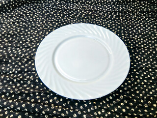 A white plate with a black background