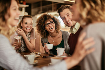 Group of young people enjoying a coffee in a cafe