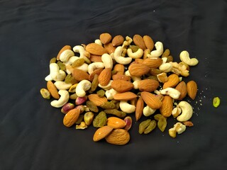 Nut & Fruit ,Almonds & Cashews Mix  Displayed  On Dark Background