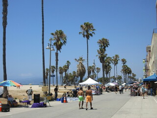 Venice Beach, California, United States - August 16th 2017 - Venice beach ocean front walk, people walking by the beach