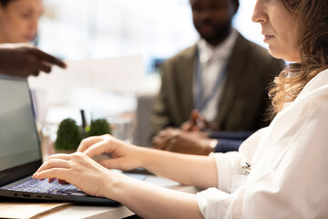 Group of professionals gather for a project management meeting, discussing key milestones and...