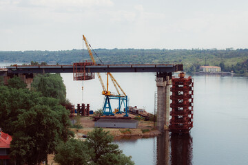 Concrete bridge over the river. Complex technical projects. A large architectural structure under...