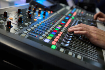 This is a professional audio mixing console that features colorful faders for enhanced usability