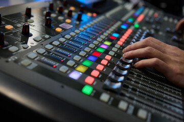 This is a professional audio mixing console that features colorful faders for enhanced usability