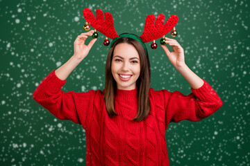Photo of young girl happy positive smile touch balls reindeer horns holiday christmas decor...