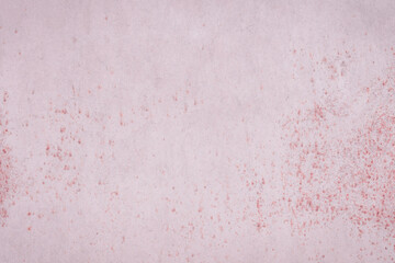 Fragment of a rusty grunge surface. Dark red background color. Scuffs and peeling of old paint. Scratches and traces of a welding seam.