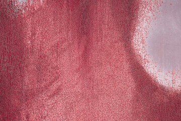 Fragment of a rusty grunge surface. Dark red background color. Scuffs and peeling of old paint....