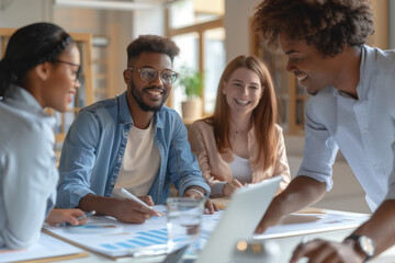 A group of young professionals collaborate in an office, enthusiastically discussing ideas. Creativity, teamwork and productivity in a goal-oriented environment. Concept: creative collaboration